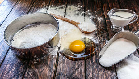 flour, egg, sieve board on a wooden boardの写真素材