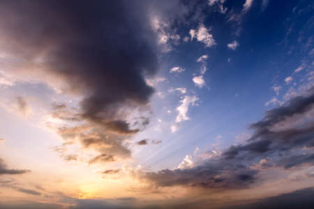 scarlet vanilla sky at sunset with cloudsの写真素材