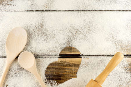 white flour sprinkled on a wooden tableの写真素材