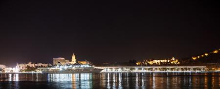 Landscape night view of Malaga from sea with night lights. Andalusia, Spainの写真素材