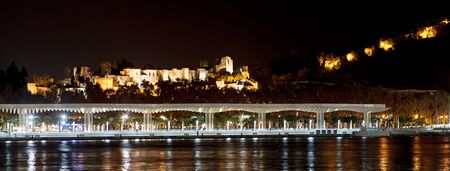 Landscape night view of Malaga from sea with night lights. Andalusia, Spainの写真素材