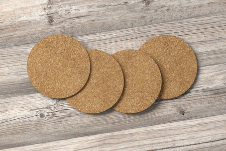 Cork coasters. Isolated on wooden background. Include clipping path. 3d renderの写真素材