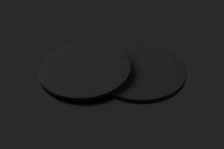 Black coasters. Isolated on black background. Include clipping path. 3d renderの写真素材