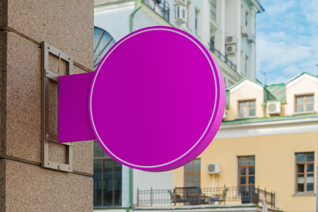 Blank magenta round singboard on the granite wall.の写真素材