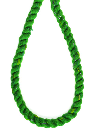 Loop of  green decorative braided curtain cord on white backgroundの写真素材