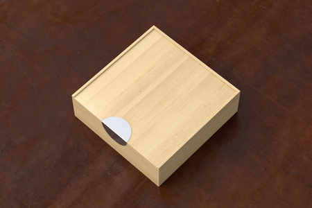 Blank light wooden square box with closed sliding lid on brown leather background. Include clipping path around box. 3d illustrationの写真素材