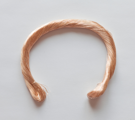 Skein of metallized thread on whiteの写真素材