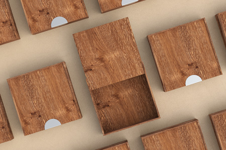 Empty dark wooden square box with opened sliding lid with closed boxes around on beige leather wooden background. 3d illustrationの写真素材