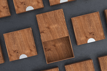 Empty dark wooden square box with opened sliding lid with closed boxes around on black background. 3d illustrationの写真素材