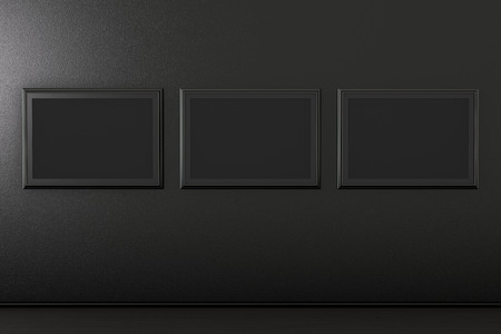 Three blank black horizontal posters design mockup on the wall in black interior. 3d illustrationの写真素材