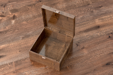 Open empty dark wooden small chest or casket on wooden background. Include clipping path around box....