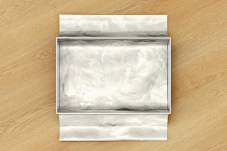 White open gift box mockup on wooden background with unfolded silver wrapping paper. Box is rectangular and flat. 3d illustrationの写真素材