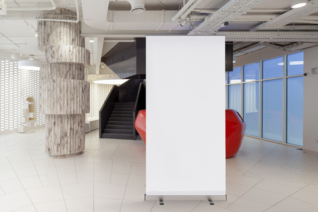 Blank roll up banner stand in office interior around ad banner. 3d illustrationの写真素材
