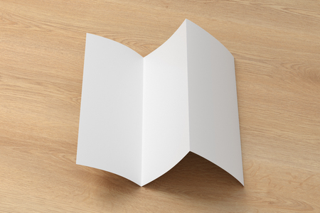 Blank trifold brochure A4 unfolded booklet on wooden background. 3D illustrationの写真素材