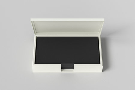 White leather business card box holder with black business cards in stack on white background. 3d illustrationの写真素材