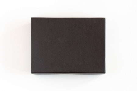 Blank black closed carton box packaging isolated on white background. View above.