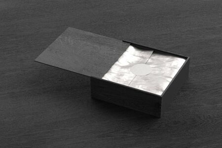 Black wooden square box with sliding lid and wrapping paper on black wooden background. 3d...