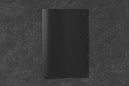 Black brochure or booklet cover mock up on black background. Isolated with clipping path around...