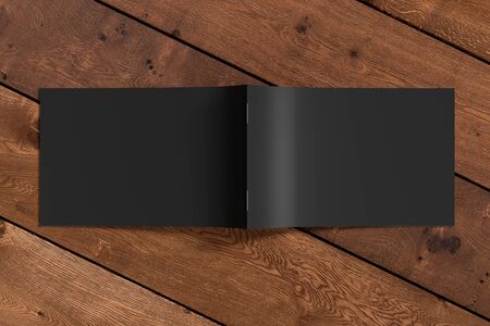 Horizontal brochure or booklet cover mock up on wooden background. Brochure is open and upside down. Isolated with clipping path around brochure. View above. 3d illustratuionの写真素材