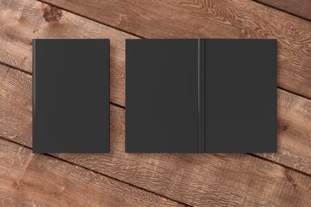 Blank black vertical closed and open and upside down book cover on wooden boardsの写真素材
