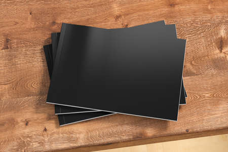 Horizontal or landscape black magazine or brochure stack mockup on wooden table. 3d illustration