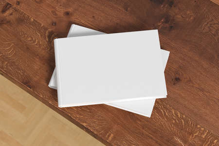 Horizontal or landscape white hardcover book stack mockup on the wooden table. 3d illustration