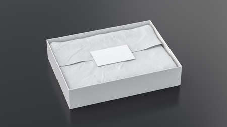 Gift box mock up. White gift box with blank label or business card on wrapping paper. Black background. Side view. 3d illustrationの写真素材