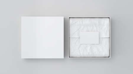 Square gift box mock up. White gift box with blank label or business card on wrapping paper. White background. View directly above. 3d illustrationの写真素材