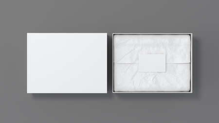 Gift box mock up with cover. White gift box with blank label or business card on wrapping paper. Gray background. View directly above. 3d illustrationの写真素材
