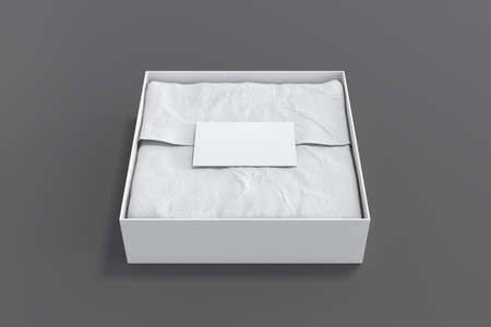 Square gift box mock up. White gift box with blank label or business card on wrapping paper. Gray background. Front view. 3d illustrationの写真素材