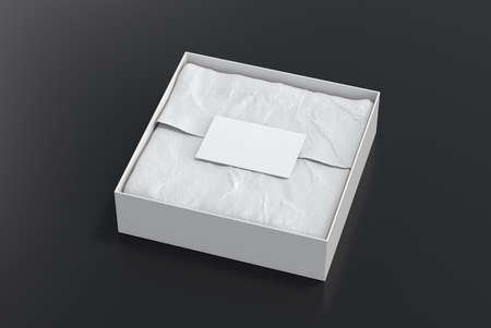 Square gift box mock up. White gift box with blank label or business card on wrapping paper. Black background. Side view. 3d illustrationの写真素材