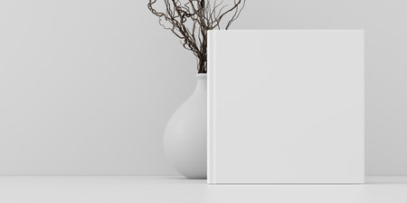 Square book cover mock up standing on a white desk with white wall background. 3d illustrationの写真素材