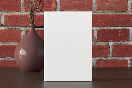Vertical book cover mock up standing on a dark wooden desk with red brick wall background. 3d illustrationの写真素材