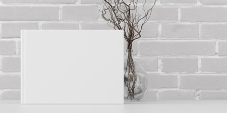 Horizontal book cover mock up standing on a white desk with white brick wall background. 3d illustrationの写真素材