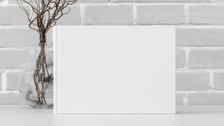 Horizontal book cover mock up standing on a white desk with white brick wall background. 3d illustrationの写真素材