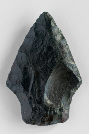 Neolithic obsidian arrowhead on white backgroundの写真素材