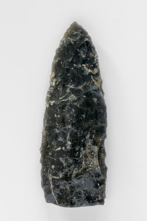 Neolithic obsidian arrowhead on white backgroundの写真素材