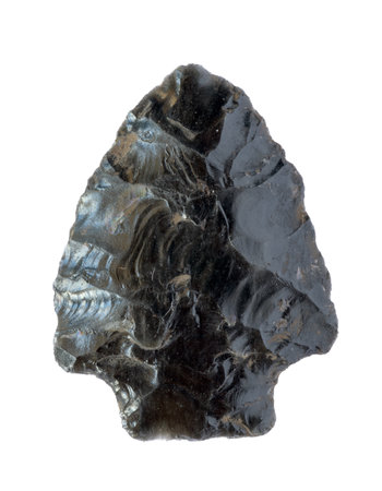 Neolithic obsidian arrowhead on white backgroundの写真素材