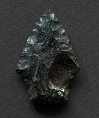 Neolithic obsidian arrowhead on dark backgroundの写真素材