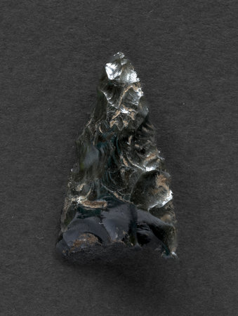Neolithic obsidian arrowhead on dark backgroundの写真素材