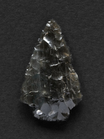 Neolithic obsidian arrowhead on dark backgroundの写真素材