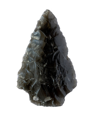 Neolithic obsidian arrowhead on white backgroundの写真素材