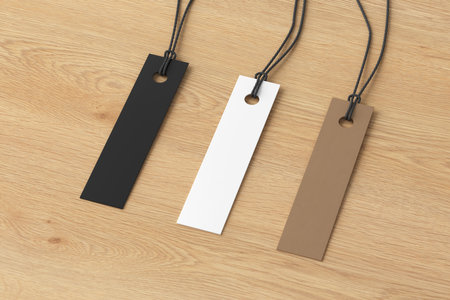 White, cardboard, black long tags mockup on wooden background. Side view. 3d illustrationの写真素材