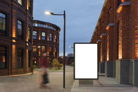 Blank advertising stand at night against office buildings. 3d renderの写真素材
