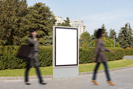 Blank advertising vertical street billboard poster on city park background.の写真素材