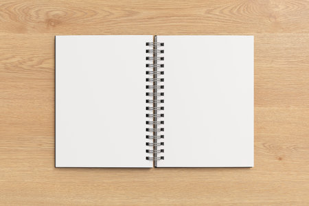 Notebook mockup. Blank notebook with black cover. Spiral notepad on wooden background. 3d illustrationの写真素材