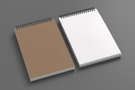 Notebook mockup. Closed and open blank notebook brown paper cover. Spiral notepad on gray background. 3d illustrationの写真素材
