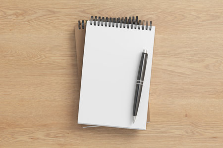 Notebook mockup. Two notebooks in a stack and pen. Spiral notepad on wooden background. 3d illustrationの写真素材