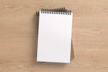 Notebook mockup. Two notebooks in a stack. Spiral notepad on wooden background. 3d illustrationの写真素材