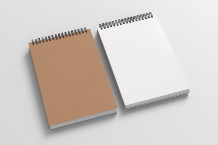 Notebook mockup. Closed and open blank notebook brown paper cover. Spiral notepad on white background. 3d illustrationの写真素材
